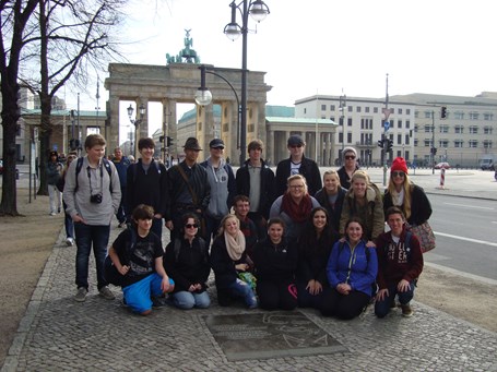 Students standing at the Ronald Reagan marker in front of the Brandenburg gate.  2014